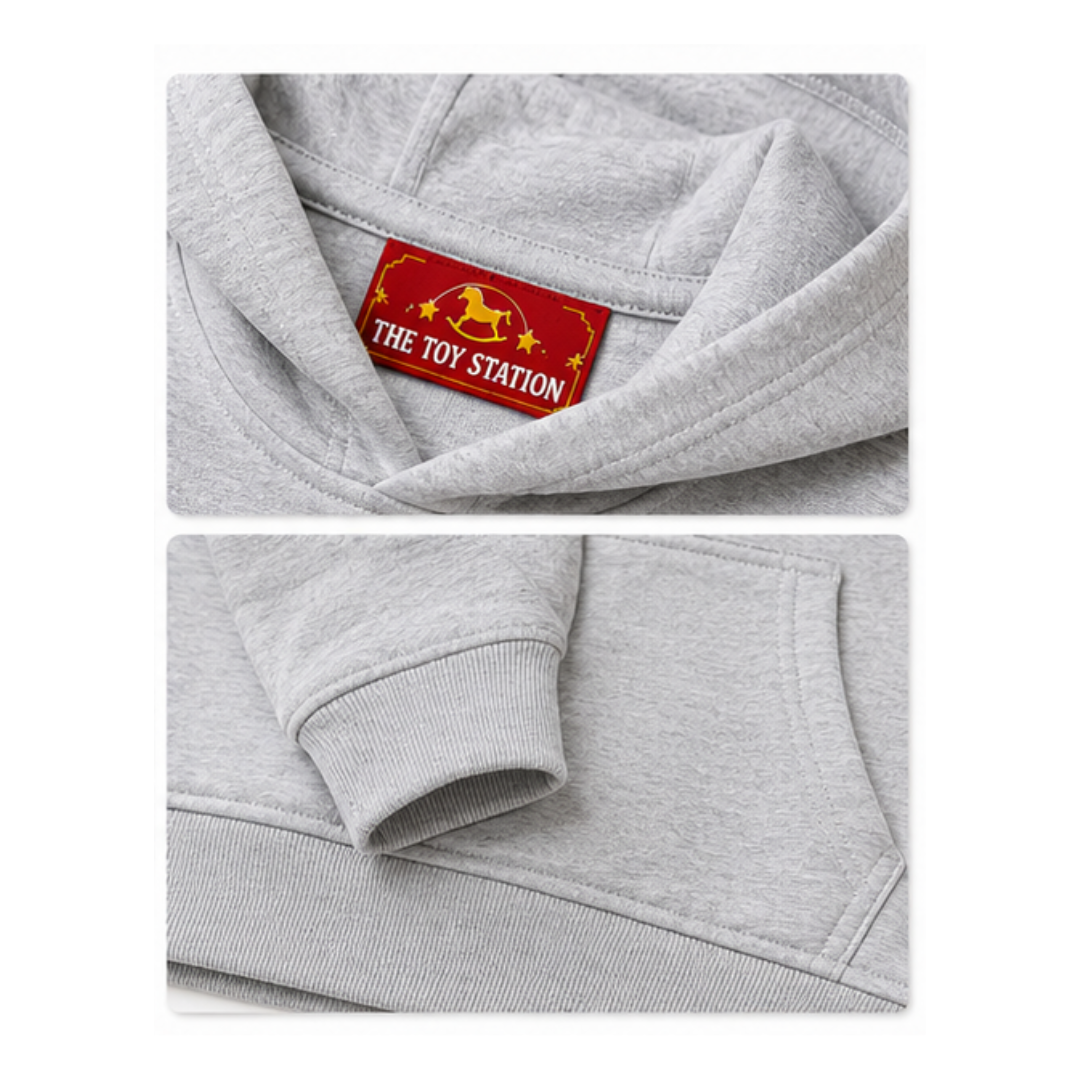 Gray hoodie with 'The Toy Station' label, soft fabric, ribbed cuffs, and cozy design for kids