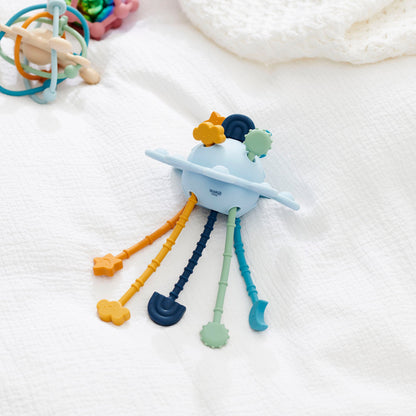 Colorful baby teether toy with star, cloud, and moon shapes on soft fabric background