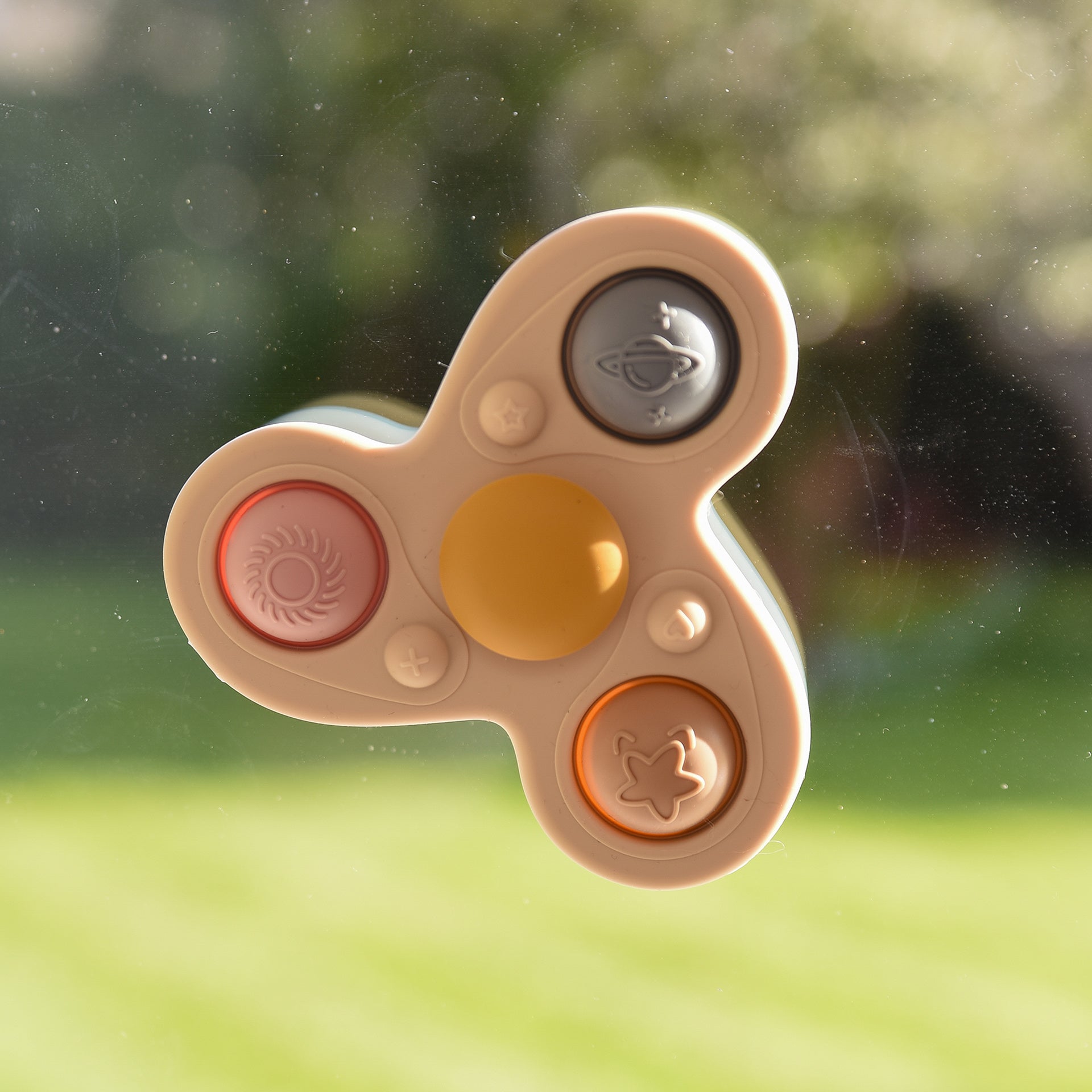 Colorful fidget spinner with space-themed buttons for sensory play and stress relief