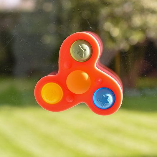 Colorful space-themed fidget spinner toy with planet, sun, and star buttons on window