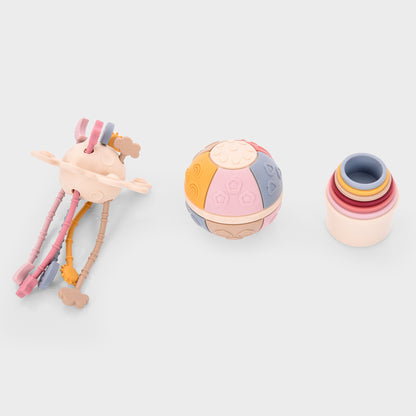 Colorful baby toys including a textured ball, stacking rings, and a multi-textured teether for sensory play