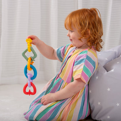 Child playing with colorful sensory teething toy rings