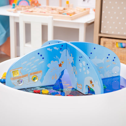 Blue wooden ocean-themed sensory play set with sea creatures, fish, and colorful gems in water tray
